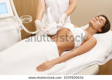 Woman during belly massage or figure correction procedure
