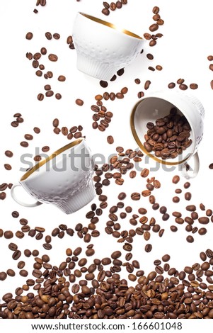 Falling coffee cups and beans over white background