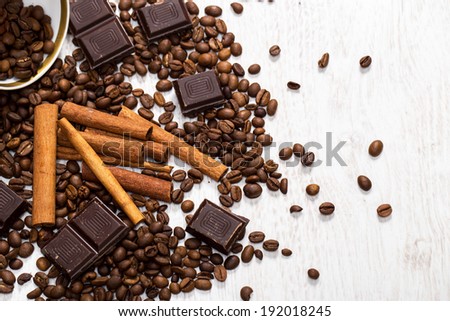 Heap of coffee beans, cinnamon stick and chocolate