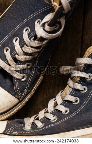 Dirty gym shoe on wooden background