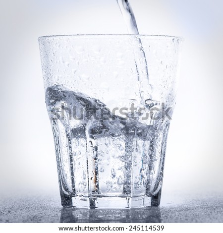 Glass with fresh water on white background