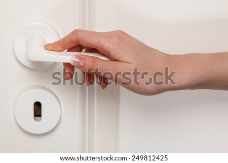 Close up of Female hand on door handle
