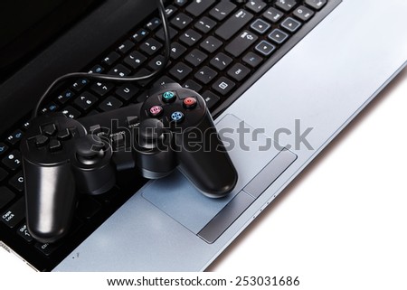 Black gamepad is lying on a laptop keyboard