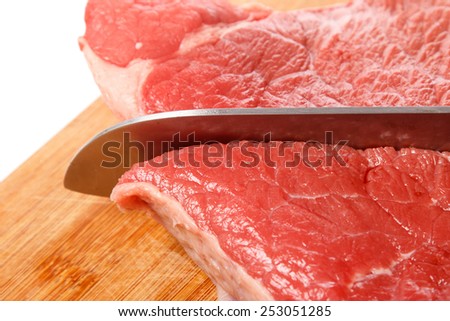 Knife and meat on chopping board