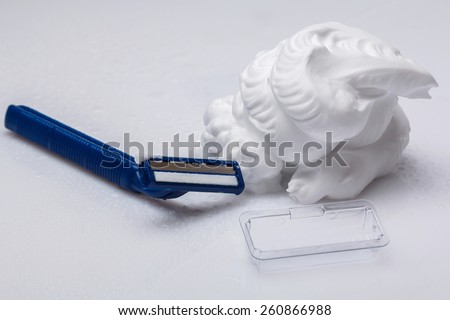 Shaving razor and foam on the table