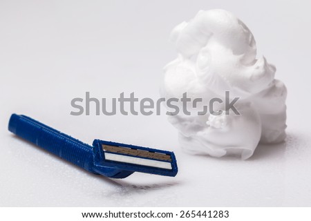 Shaving razor and foam on the table
