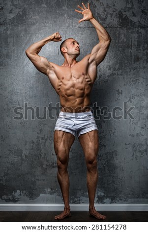Sexy and muscular man  posing against stone wall