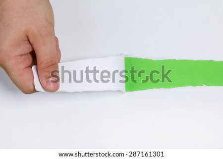 Hand tear a strip of white paper