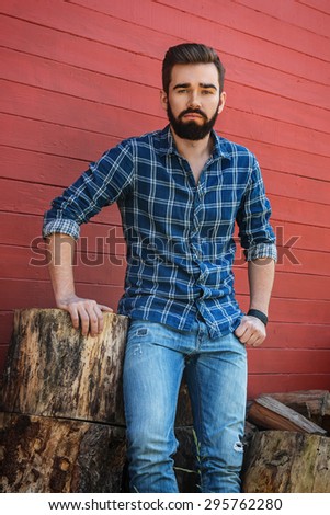 Handsome bearded man in checkered shirt