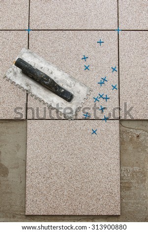 Installation of floor tiles. Ceramic tiles and different tools