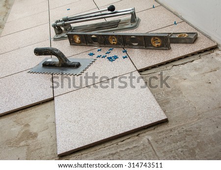 Installation of floor tiles. Ceramic tiles and different tools