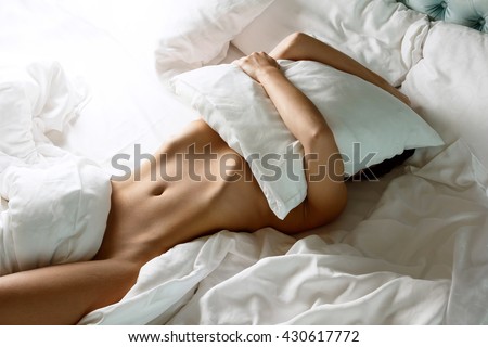 Woman with a beautiful belly lying on the bed