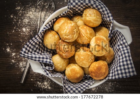 Danish Ebelskiver Pancakes Served in a bowl with a blue and white gingham napkin on a wood table top