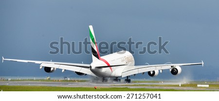 AUCKLAND, NEW ZEALAND - APR 13: Emirates brand new A380 is taxiing at the Auckland International Airport as seen on April 13, 2015. A380 is the largest commercial plane in the world.
