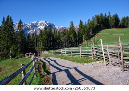National park Durmitor in the Montenegro. Mountains in the snow and road with fence. Forest near the mountains.