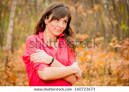 Charming lady posing on autumn background