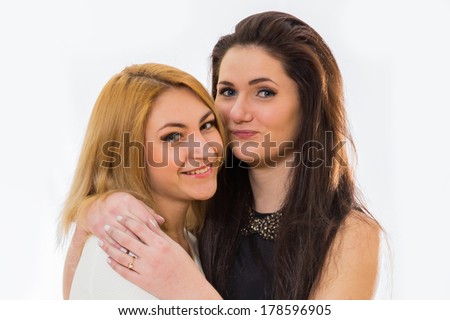 Two friends girls making faces isolated on white background