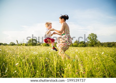 mother and son playing in the field