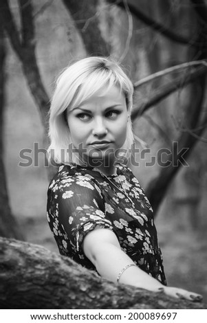 Blond young woman in the forest.Black and white