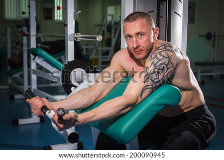 Man with tattoo in the gym