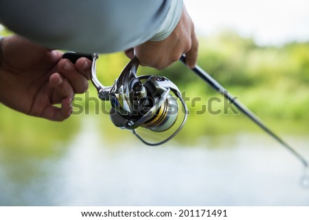 Fisherman with spinning on the river