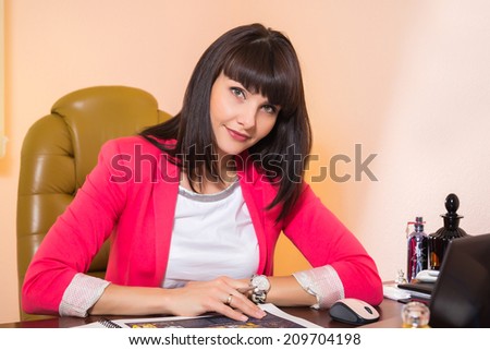 Black and white.Woman in a business suit. Business woman sitting at the table, working with the computer. Business, work, business woman - business concept girl. The idea about the woman\'s business.