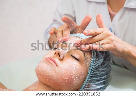 ?osmetic procedures in spa clinic.Beautician performs cosmetic procedures.applying cosmetic cream. Cosmetology, facial, beauty - The concept of facial skin care. Article about cosmetology.