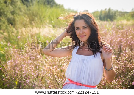 Free Happy Woman Enjoying Nature. Beauty Girl Outdoor. Freedom concept. Beauty Girl in the field. Enjoyment.Portrait of the young beautiful smiling woman outdoors.A beautiful girl enjoying summer sun