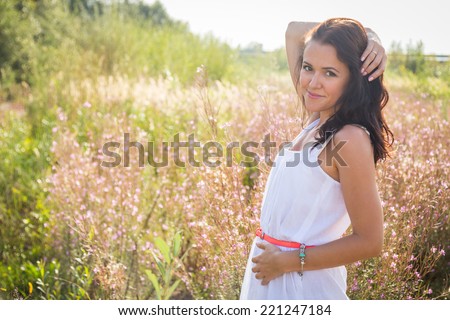 Free Happy Woman Enjoying Nature. Beauty Girl Outdoor. Freedom concept. Beauty Girl in the field. Enjoyment.Portrait of the young beautiful smiling woman outdoors.A beautiful girl enjoying summer sun