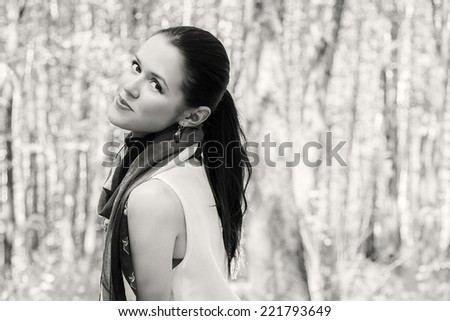 Portrait of a brunette in a forest.Enjoying the nature. Young woman enjoying the fresh air in green forest.