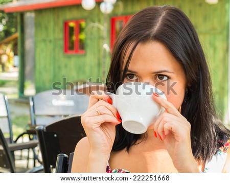 rtrait of the beautiful woman, drinking coffe in day.Beautiful girl drinking coffee.beautiful young girl drinking coffee in n cafe - outdoor portrait