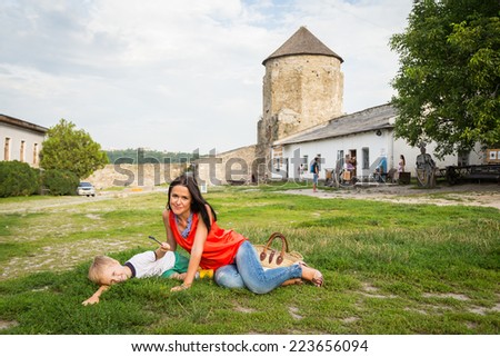 A family trip to a medieval castle. Mom and son on the stairs of a medieval fortress. Travel, family, stairs, family holiday - Travel Concept