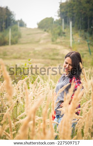 Beautiful girl in the mountains. Girl in high grass. Travel, tourism, trekking in the mountains - The concept of active rest.
