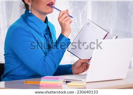 Woman in a business suit. Business woman sitting at the table, working with the computer. Business, work, business woman - business concept girl. The idea about the woman\'s business.