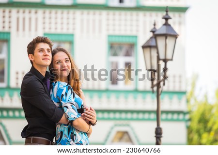 Young couple in love traveling around the beautiful city. Young people hugging and kissing on the streets.Young couple in love, hugging on the street.Happy young couple  on the city street.