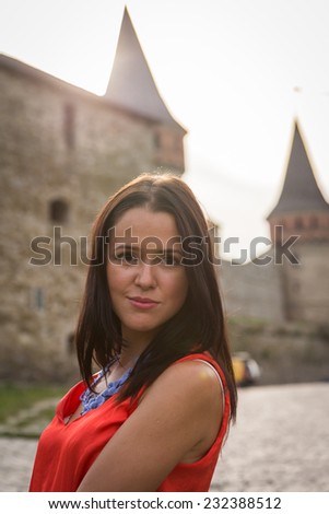 Young girl on the street. Brunette travels the most beautiful European, ancient city. Beautiful  background. Travel, old city - Travel Concept.