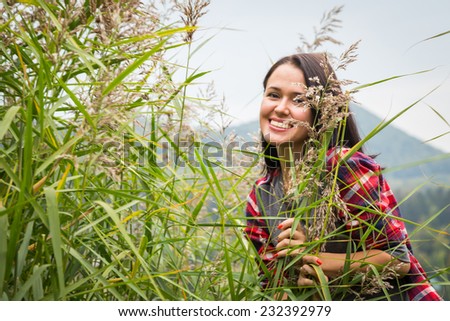 Beautiful girl in the mountains. Girl in high grass. Travel, tourism, trekking in the mountains - The concept of active rest.