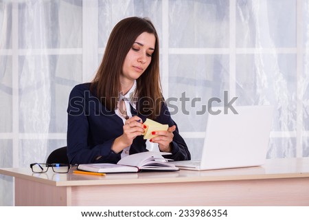 Student works in the office. She works at her laptop.Woman working at the computer on office background.Portrait of businesswoman with laptop.
