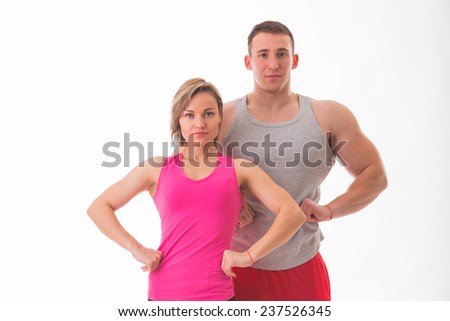 Sports man and woman posing on a white background. Athletic couple in sportswear. Fitness, sports, good shape, the pair - the concept of family fitness.