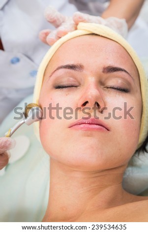 Medical cosmetic procedure. Mikronidling. Beautician performs Dermaroller procedure.young beautiful woman having an injection mesotherapy.Cosmetic procedures in spa clinic.