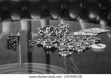Playing poker chips on a glass table. Playing cards on a gambling table. Gambling, dice, poker.