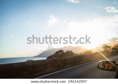 Beautiful Mediterranean landscape from the window of the car. Sunset in the coastal seaside town. Sea Sunset View from the road for cars.