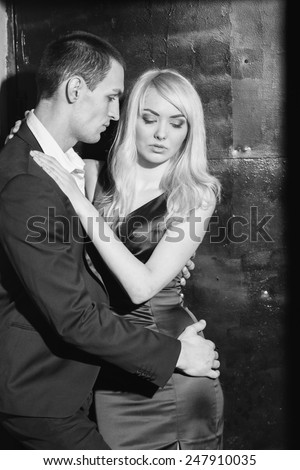Black and white. Love, passion, jealousy, loyalty, feelings, sex - emotion lovers. Start a love story. Young couple in love.Loving couple standing in the doorway together, woman hugging her boyfriend.