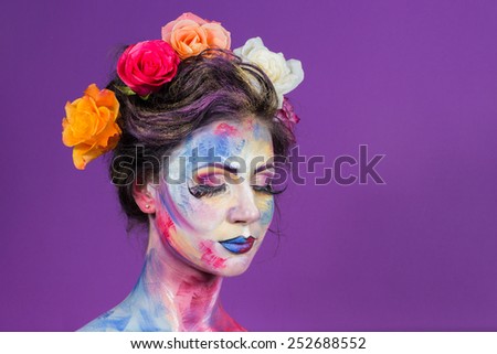 The creative, bright, color makeup. Floral makeup. Art makeup. Beautifully painted lips and eyes. Tone, powder, make-up. Multi-colored roses in her hair girl.