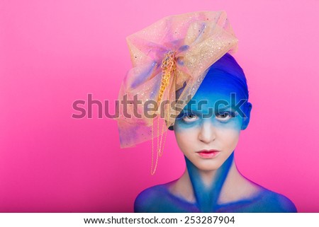 Creative makeup. Airbrush. Blue, indigo, violet makeup. Creative eye make-up, hair. Golden headdress on the girl.