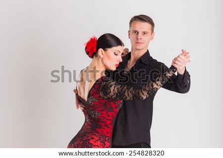 Ballroom dancing. Man and woman posing in dance pose on white. Man and woman dancing ballroom dances. Beautiful man and woman doing the dance steps. Dance poses.