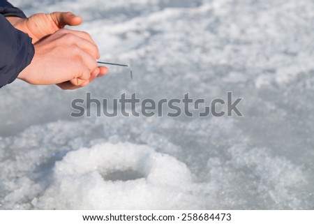 Winter ice fishing. Fishing rod for ice fishing. Hobbies, winter fishing.