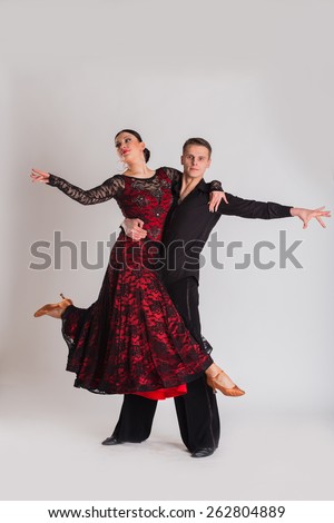 Ballroom dancing. Man and woman posing in dance pose on light. Man and woman dancing ballroom dances. Beautiful man and woman doing the dance steps. Dance poses.