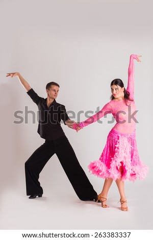 Ballroom dancing. Man and woman posing in dance pose on light. Man and woman dancing ballroom dances. Beautiful man and woman doing the dance steps. Dance poses.