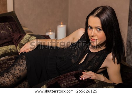 Portrait of a beautiful brunette. Girl lying in the bedroom. positive emotions.